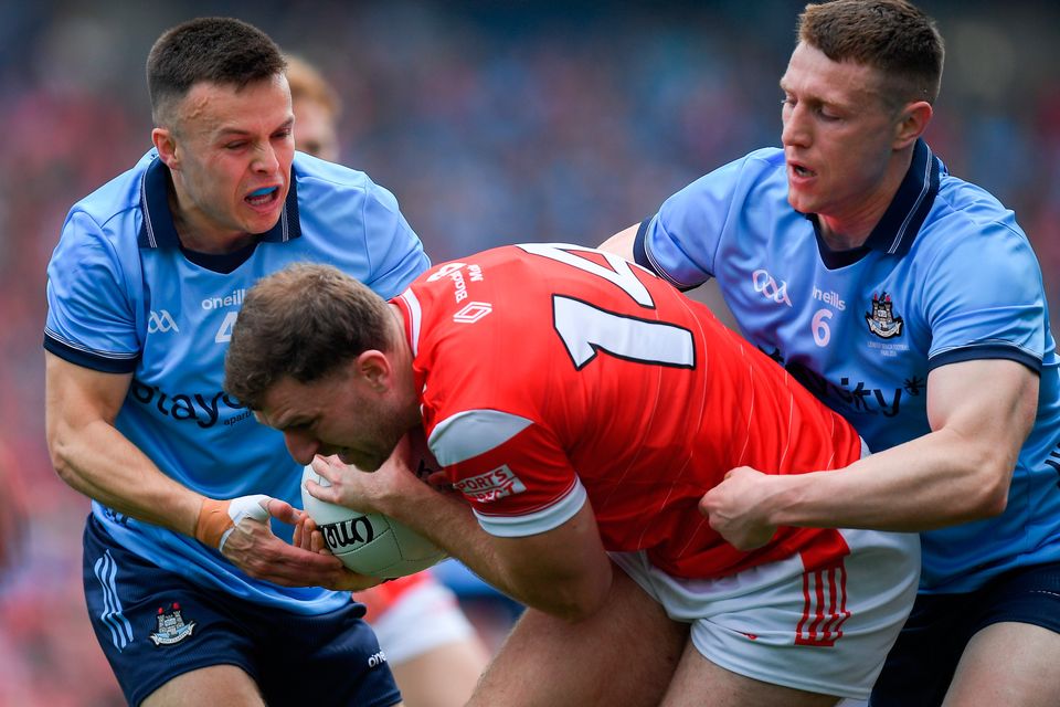 Eoin Murchan, left, and John Small tackle Sam Mulroy of Louth during the Leinster SFC final in Croke Park. Photo: Shauna Clinton/Sportsfile