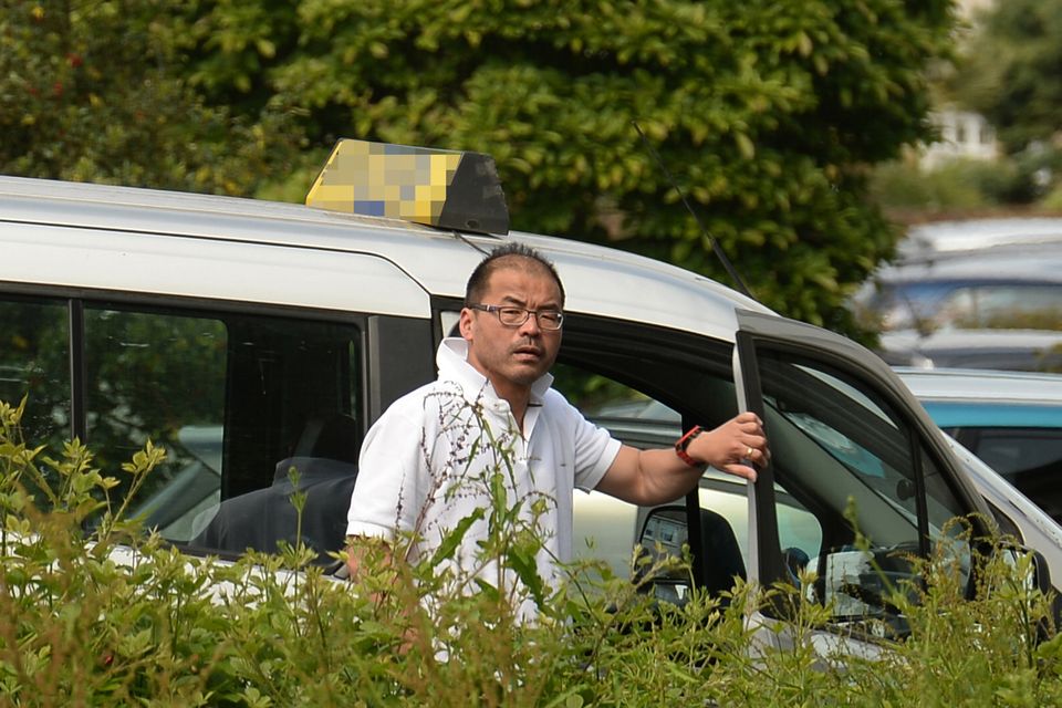 Le Wang in his taxi, just days after his conviction