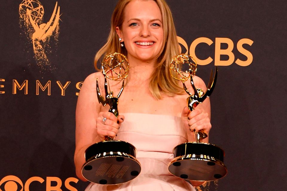 TOPSHOT - Elisabeth Moss poses with the awards for  Outstanding Drama Series and Outstanding Lead Actress in a Drama Series for "The Handmaid's Tale" during the 69th Emmy Awards at the Microsoft Theatre on September 17, 2017 in Los Angeles, California. / AFP PHOTO / Mark RALSTONMARK RALSTON/AFP/Getty Images