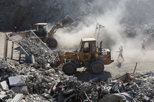 Palestinians using mountains of war rubble to repave streets destroyed during Israel’s two-year onslaught