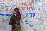 thumbnail: An unidentified girl writes messages for MH370 in Kuala Lumpur.