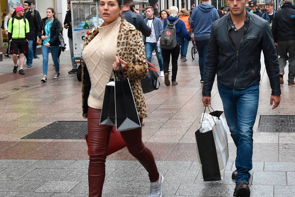 A make-up free Kelly Brook and  boyfriend Jeremy Parisi spotted shopping on Grafton Street carrying Brown Thomas bags