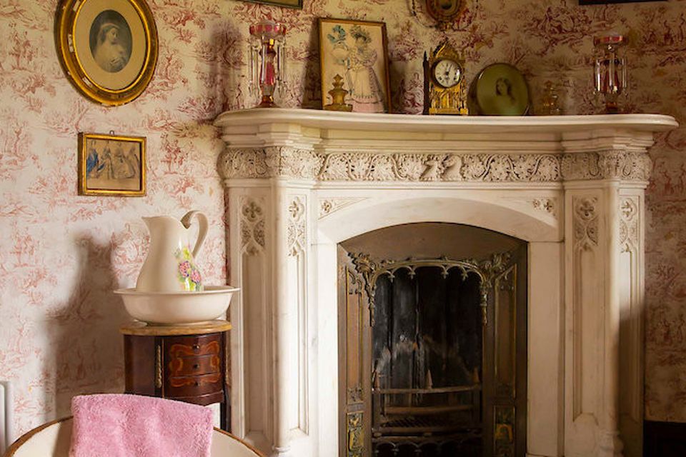 The curved fireplace and walls of the boudoir off the bedroom