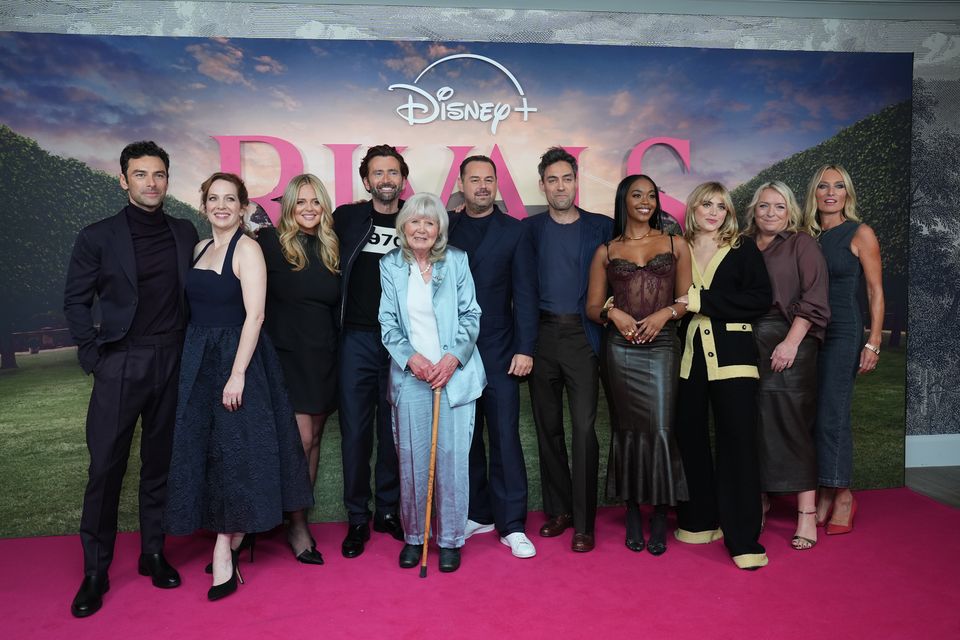 The cast of Rivals with author and executive producer Dame Jilly Cooper (Lucy North/PA)