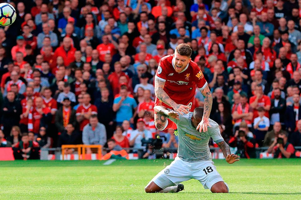 Liverpool’s Alberto Moreno goes over the top of Manchester United’s Ashley Young during yesterday’s Premier League match at Anfield. Photo: PA Wire