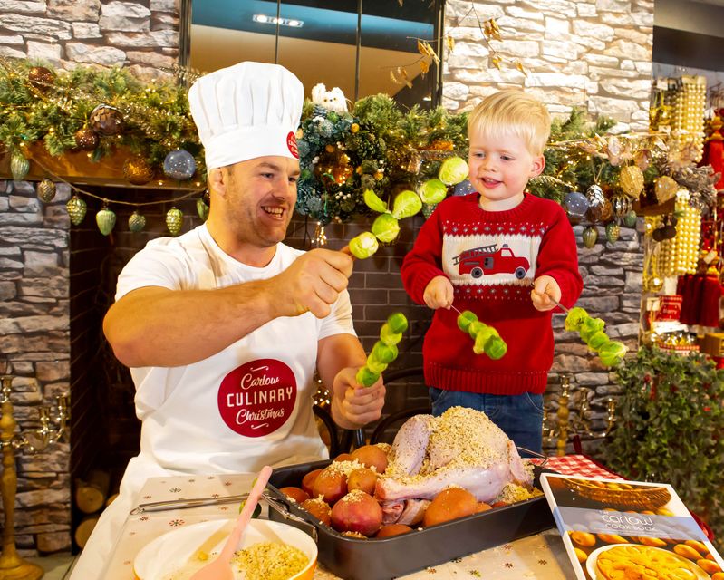 Rugby giant and proud Carlow man, Sean O'Brien, prepares for Carlow Culinary Christmas with three year-old Iarlaith Flannery at The Arbortetum. Photo: Mary Browne