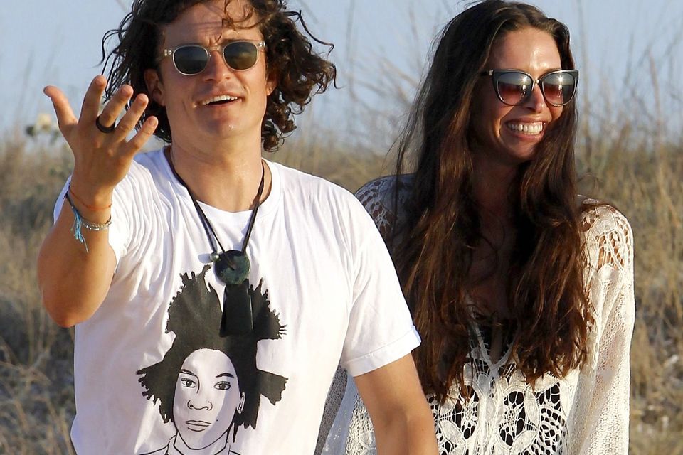 Orlando Bloom having a good time with Erica Packer and friends at restaurant in Formentera