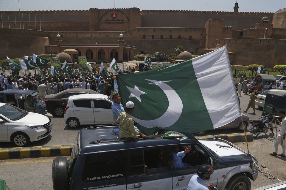 People with national flags joined a demonstration to show their support for the Pakistan Army in Peshawar, Pakistan, on Sunday (Muhammad Sajjad/AP)