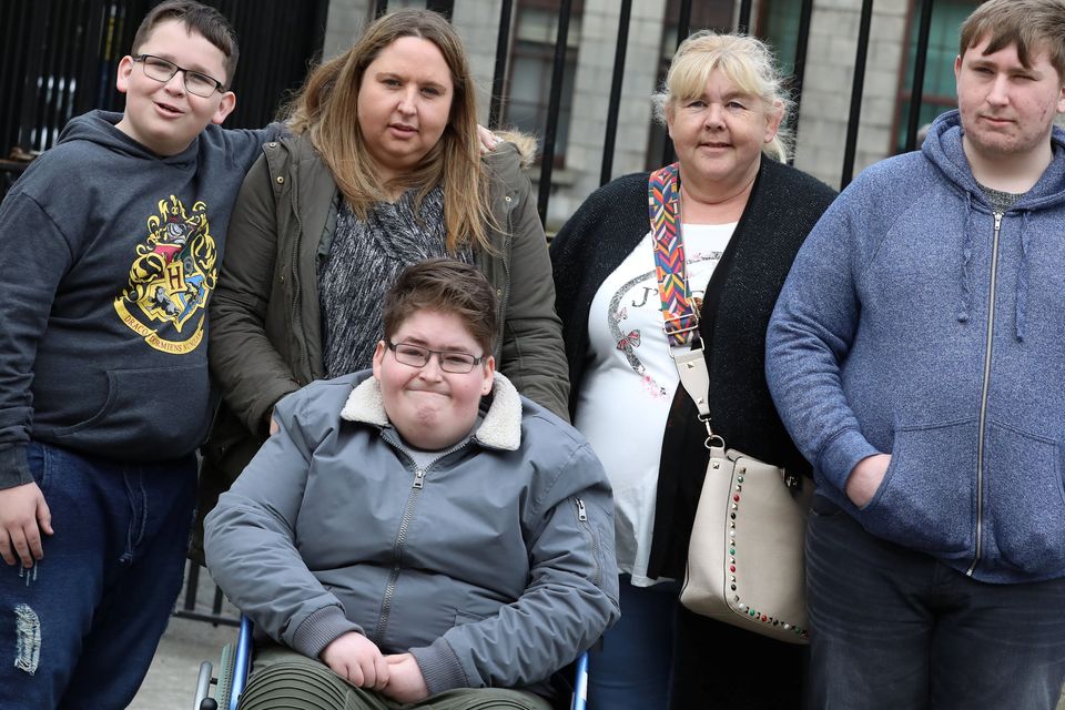 The Sweeney family (l-r)- James (11), (In wheelchair) Stephen (15) and Jason (17) pictured leaving the Four Courts with their mum, Michelle Sweeney (Second from left in pic) and their grandmother, Linda (second from right in pic) Picture: Collins Courts