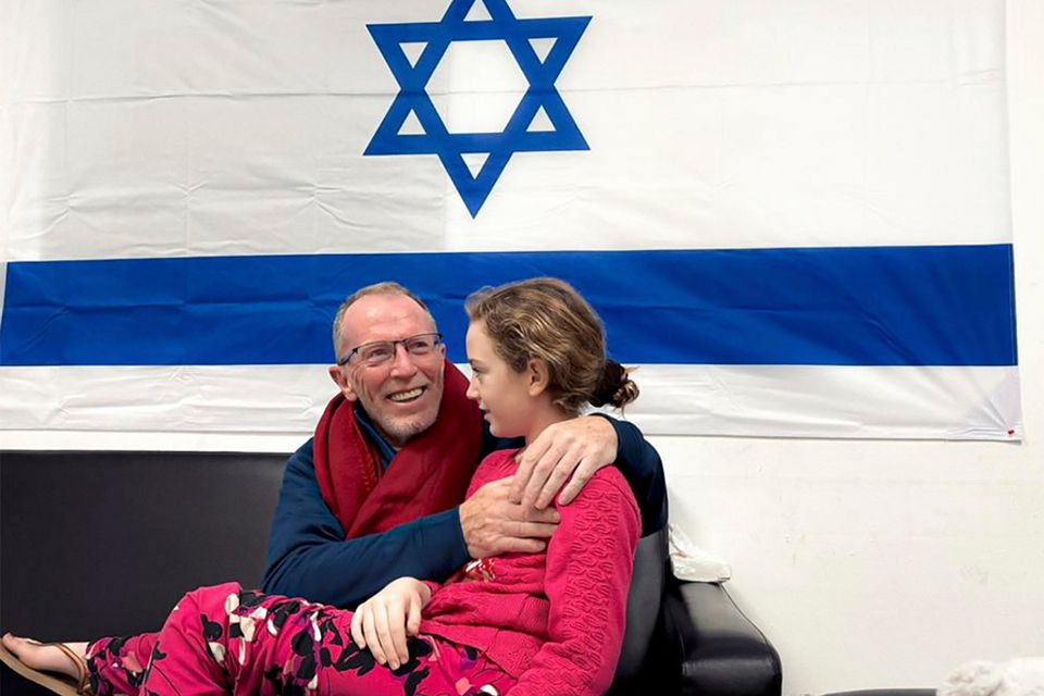 Released hostage Emily Hand is reunited with her father Thomas last Sunday. Photo: AP