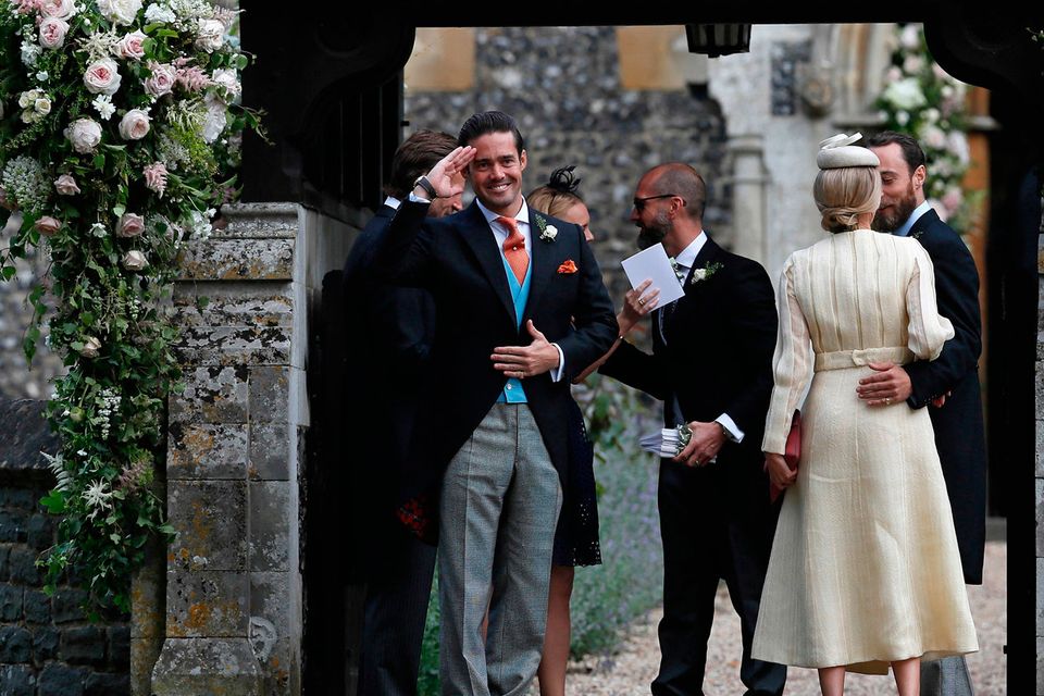 Spencer Matthews (left), the brother of groom James Matthews, 
stands at the entrance of St Mark's Church in Englefield, ahead of his brother's wedding to Pippa Middleton