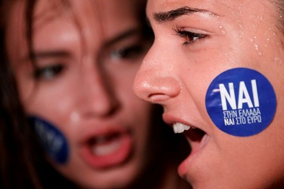 The word 'Yes' in Greek is seen on a sticker as pro-Euro demonstrators attend a rally in front of the parliament building, in Athens, Greece, June 30, 2015. Greece's conservative opposition warned on Tuesday that Sunday's vote over international bailout terms would be a referendum over the country's future in Europe, and that wages and pensions would be threatened if people were to reject the package