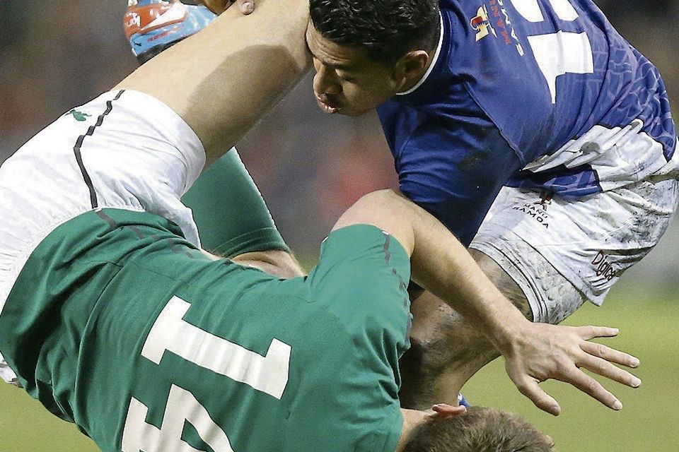 Ireland's Tommy Bowe is tackled by Samoa's George Pisi. Picture credit: John Dickson / SPORTSFILE