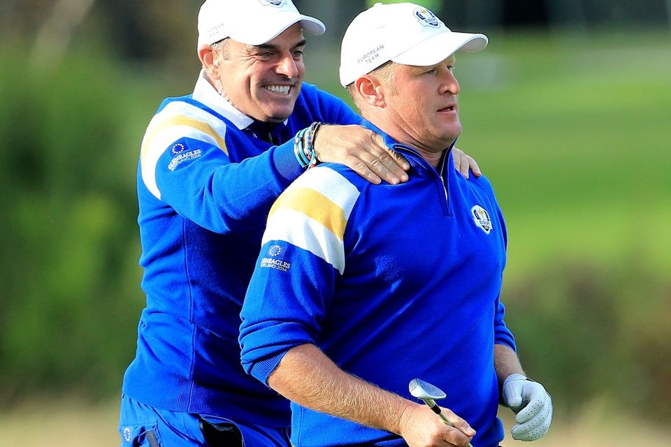 Europe's captain Paul McGinley congratulates Jamie Donaldson on the 15th hole shortly before sealing the Ryder Cup victory after Donaldson defeated Keegan Bradley