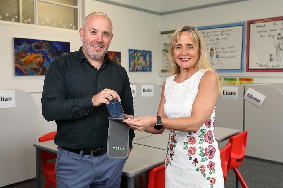 Principal Siobhan Foster and deputy principal Michael Kirwan, of De La Salle College, Churchtown, Dublin, with a Yondr phone pouch. Photo: Frank McGrath