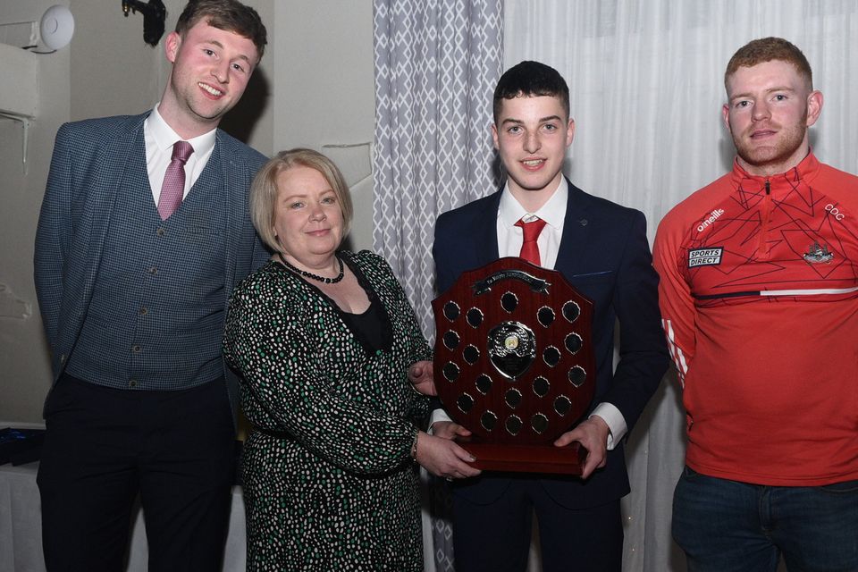 Eileen Murphy presents the Pat Murphy Memorial Trophy for the Banteer/Lyre Juvenile GAA Footballer of the Year Award to Jack Finnegan in the company of team manager Barry Murphy and special guest Conor O'Callaghan at the Club Victory Function, Picture John Tarrant