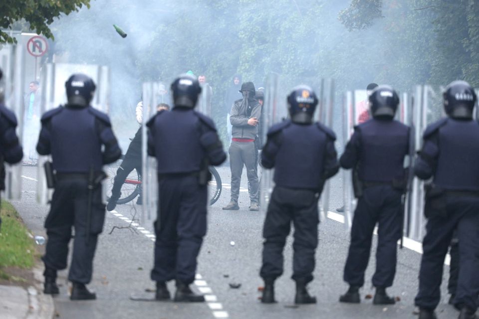 Protesters throw objects at gardaí outside the former Crown Paints factory in Coolock Dublin. Photo: Colin Keegan/Collins Photos