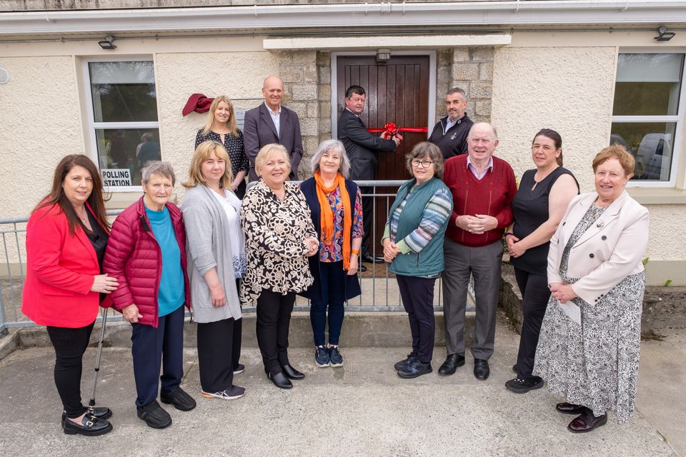 Cllr Pat Kennedy cutting the ribbon on the community hall, with Michael Nicholson of Wicklow County Council, and the Ballinaclash Community Association committee.