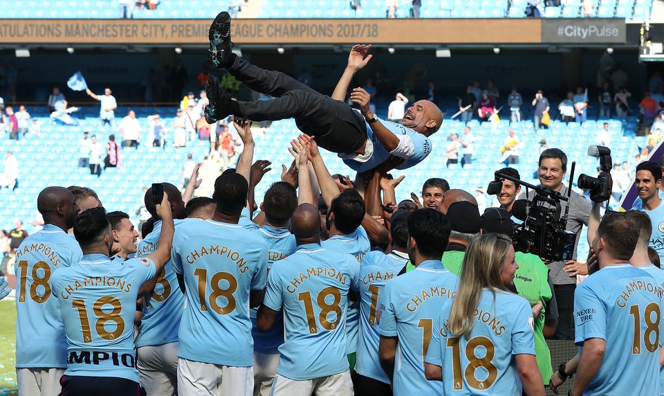 Manchester City celebrate yet another trophy under manager Pep Guardiola (Martin Rickett/PA)