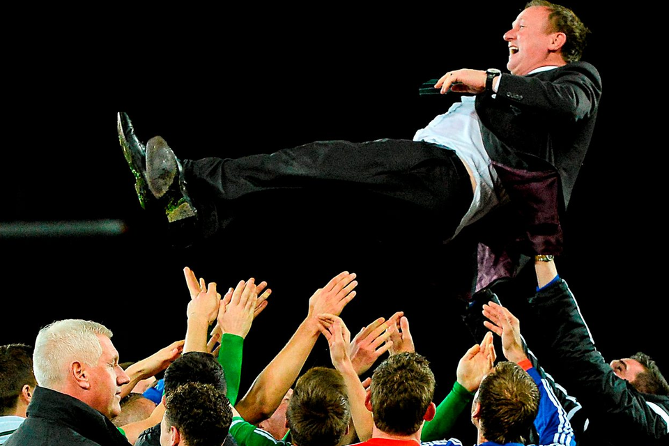 Northern Ireland manager Michael O'Neill gets thrown in the air by his players during the celebrations after the game