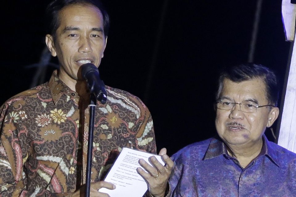 Indonesian president-elect Joko Widodo, left, delivers his victory speech as vice president-elect Jusuf Kalla listens on in Jakarta (AP)
