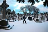 thumbnail: A man on his way to work walks through Glasnevin cemetery in Dublin as heavy snow has caused more misery for travellers overnight. Photo: Brian Lawless/PA Wire