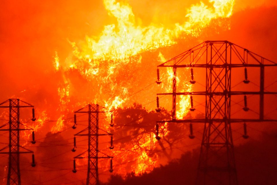The Thomas Fire burns near power lines in Sycamore Canyon off West Mountain Drive in Montecito, California Photo: Mike Eliason/Santa Barbara County Fire Department via AP
