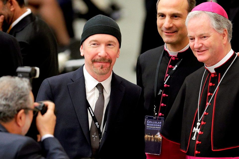 The Edge poses for a picture with Irish bishop Paul Tighe (right) at the Vatican. Photo: Reuters