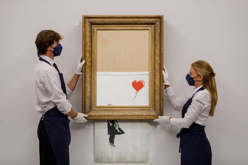 Handout photo issued by Sotheby’s of Banksy’s Love Is In The Bin’, being auctioned at Sotheby’s, London, where it sold for £18,582,000 (Sotheby’s/PA)