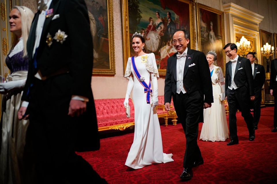 Britain's Princess of Wales wears 'Monserrat' gloves by Irish designer Paula Rowan as she walks with the deputy prime minister of South Korea ahead of a state banquet at Buckingham Palace,. Photo: PA