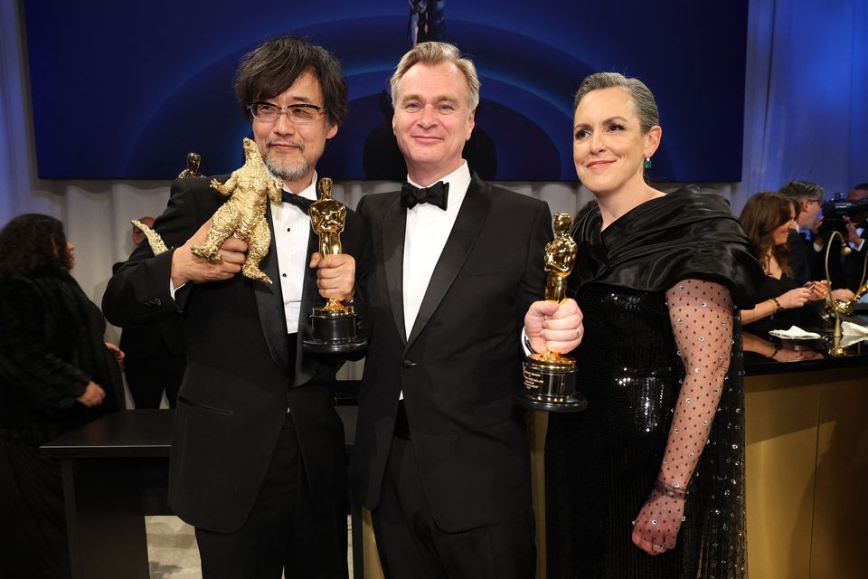 Christopher Nolan and Emma Thomas, winners of the Oscar for Best Picture for "Oppenheimer", pose with Takashi Yamazaki, winner of the Oscar for Best Visual Effects for "Godzilla Minus One", at the Governors Ball following the Oscars show at the 96th Academy Awards in Hollywood, Los Angeles, California, U.S., March 10, 2024.