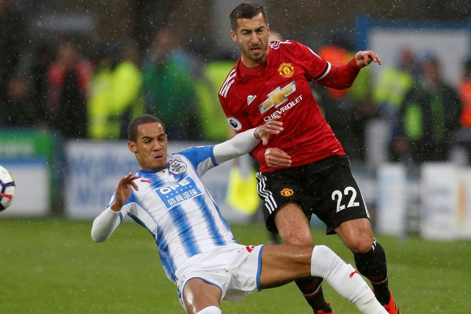 Huddersfield’s Tom Ince puts in a challenge on Manchester United’s Henrikh Mkhitaryan at John Smith’s Stadium   Photo: Reuters