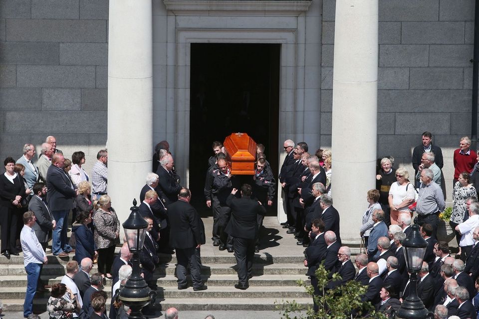 Mourners watch as the coffin of Martina Hayes is carried from the Church of Saints Peter and Paul in Athlone