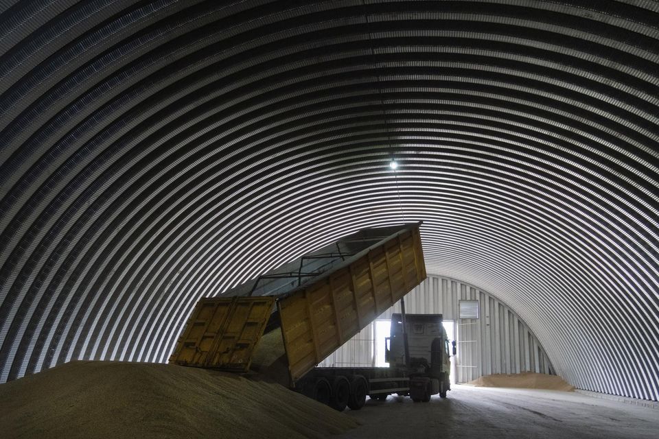 A dump track unloads grain in a granary in the village of Zghurivka, Ukraine (Efrem Lukatsky/AP/PA)