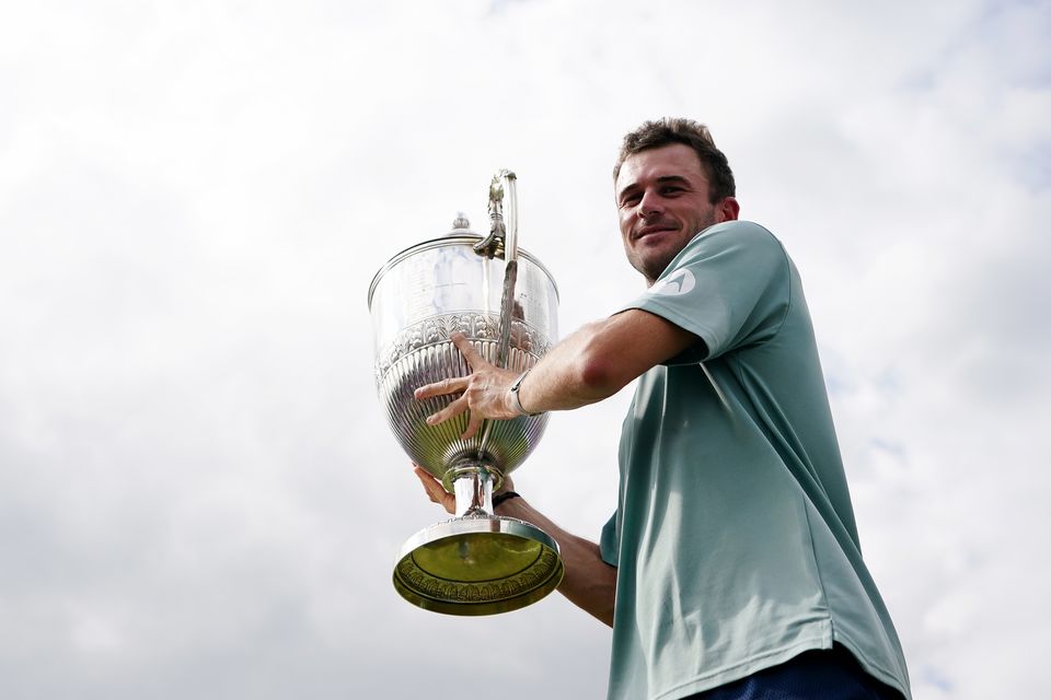 Tommy Paul holds the trophy at Queen’s Club (Zac Goodwin/PA)