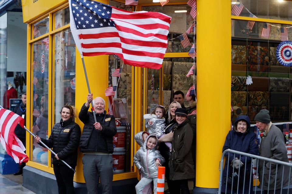 People hold American flags as U.S. President Joe Biden visits Dundalk, Ireland, April 12, 2023. REUTERS/Clodagh Kilcoyne