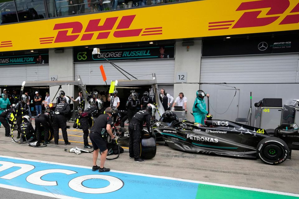 Mercedes' Lewis Hamilton makes a pit stop during the race. Pool via REUTERS/Darko Vojinovic