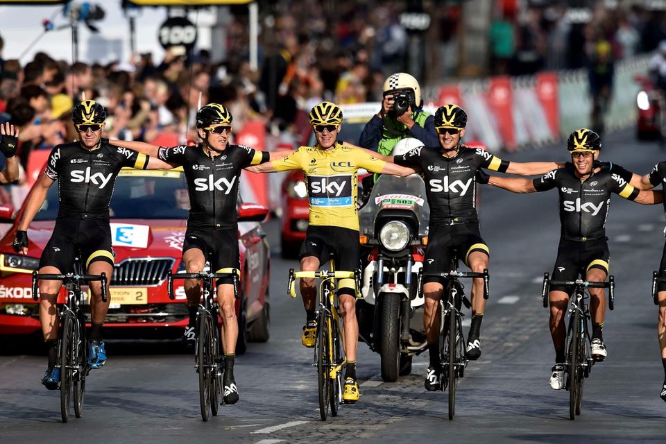 Christopher Froome (C), wearing the overall leader's yellow jersey, arrives with his teammates of the Great Britain's Sky cycling team to cross the finish line on the Champs-Elysees avenue at the end of the 109,5 km twenty-first and last stage of the 102nd edition of the Tour de France cycling race on July 26, 2015, between Sevres and Paris.    AFP PHOTO / ERIC FEFERBERGERIC FEFERBERG/AFP/Getty Images
