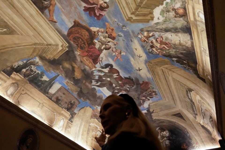 FILE – Princess Rita Boncompagni Ludovisi stands beneath a fresco by Italian Baroque painter Giovanni Francesco Barbieri, known as Guercino, inside The Casino dell’Aurora, also known as Villa Ludovisi, in Rome, Tuesday, Nov. 30, 2021. The villa containing the only known ceiling painted by Caravaggio goes on the court-ordered auction block Tuesday, Jan. 18, 2022 with an estimated value of nearly a half-billion euros (dollars), thanks to an inheritance dispute pitting the heirs of one of Rome’s aristocratic families against their step-mother, a Texas-born princess. (AP Photo/Gregorio Borgia, File)