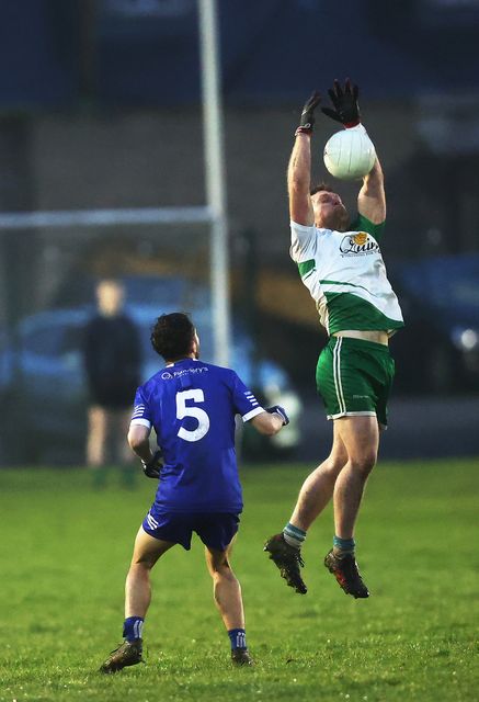 Cian Lee of Baltinglass gathers as Mark O'Brien of St. Pat's looks on.  