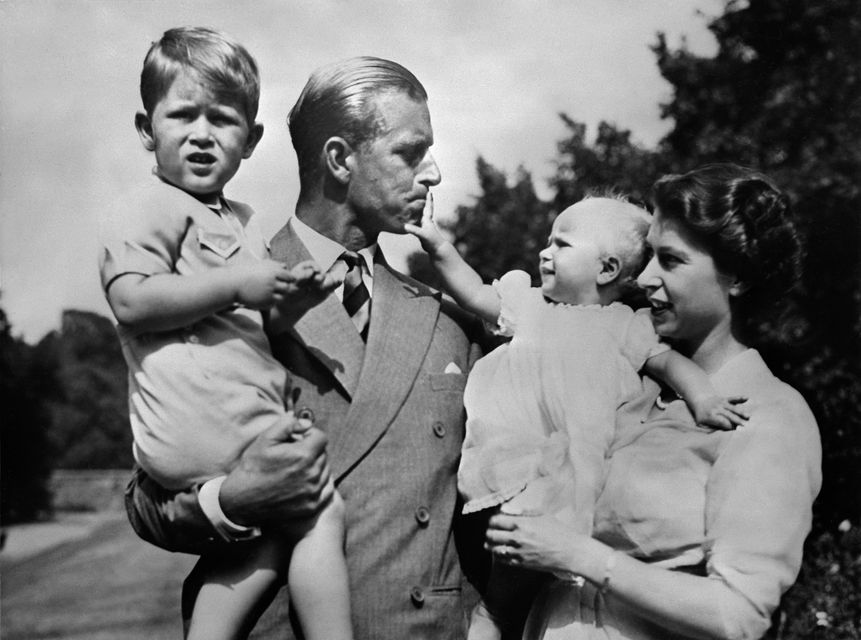 Undated picture showing the Royal British couple, Queen Elizabeth II, and her husband Philip, Duke of Edinburgh, with their two children, Charles, Prince of Wales (L) and Princess Anne (R), circa 1951. (Photo credit should read OFF/AFP/Getty Images)