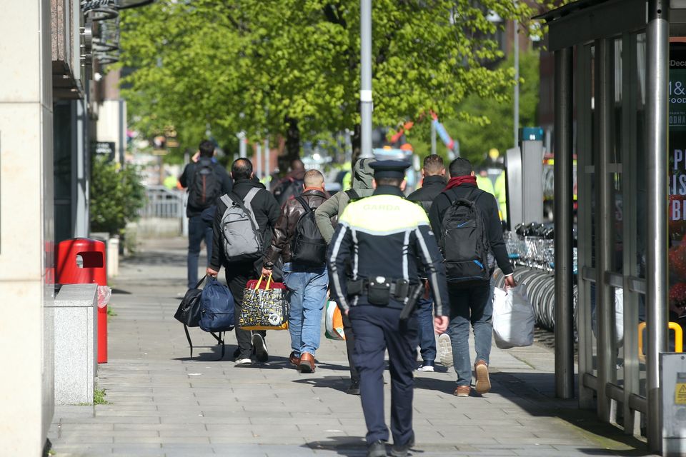 Asylum-seekers are moved away from Mount Street in Dublin during a multi-agency operation. Photo: Collins