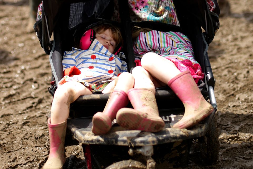 Sally Fielding pushes her daughters Lily, three, and Maisie, five, through the mud
