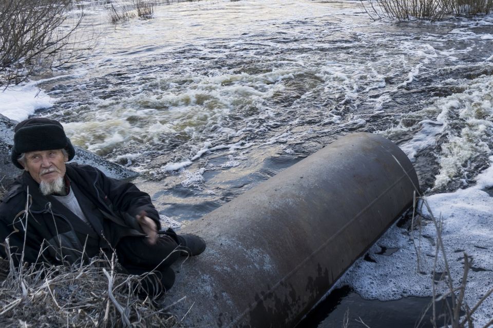 An old man fishes in a lake that connects to the nearby Techa River, near the village of Muslyumovo, Chelyabinsk region, Russia, which is polluted with radioactive waste from the Mayak nuclear plant (AP)