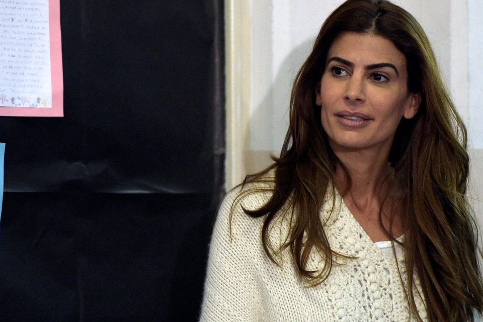 Juliana Awada wife of Buenos Aires Mayor and presidential candidate for "Cambiemos" party Mauricio Macri waits to her husband while voting at a polling station in Buenos Aires on October 25, 2015