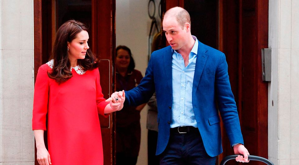 The Duke of Cambridge holds the hand of his wife, the Duchess of Cambridge, as he carries their newborn son from the Lindo Wing at St Mary's Hospital in Paddington, London