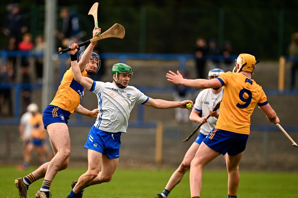 Tom Barron of Waterford in action against David Fitzgerald of Clare