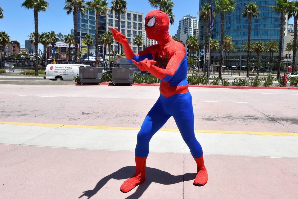 A fan dressed as Spiderman practices his moves outside of the convention center on day 1 of the 2014 Comic-Con International Convention held Thursday, July 24, 2014 in San Diego