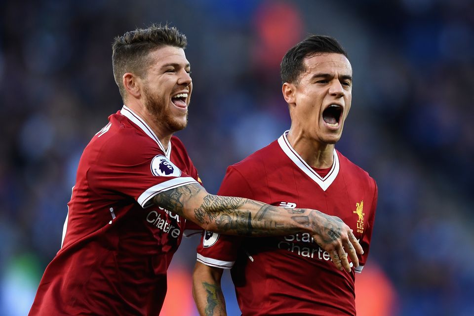 Philippe Coutinho of Liverpool celebrates scoring his sides second goal with Alberto Moreno during the Premier League match between Leicester City and Liverpool at The King Power Stadium on September 23, 2017 in Leicester, England.  (Photo by Michael Regan/Getty Images)