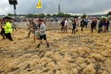thumbnail: Hay is laid over the mud in front of the Pyramid Stage